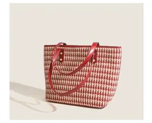 Houndstooth tote bag detail, red leather strap, knit fabric, elegant daily style accessory.