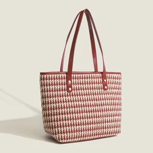 Fashionable houndstooth tote bag for women, large capacity shoulder bag with red leather handles.