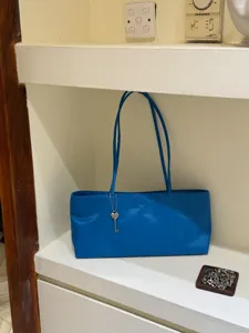Blue minimalist shoulder underarm bag for women, stylish tote bag with heart key pendant.
