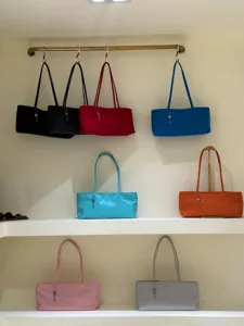 Minimalist nylon tote bag featuring a sleek shoulder strap and cute key pendant charm design.