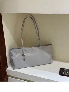 Minimalist grey shoulder tote bag with heart key charm, lightweight casual handbag for women.