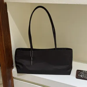 Minimalist black shoulder tote bag for women, casual nylon underarm bag with key pendant.
