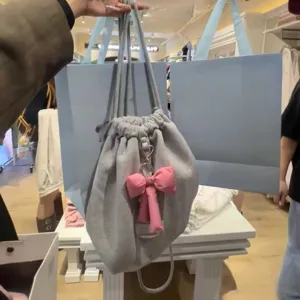 Grijze trekkoord rugzak voor dames met roze strik, casual minimalistische Koreaanse tas.