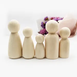 Close-up of unfinished wooden peg dolls family set, smooth natural wood for DIY crafts.