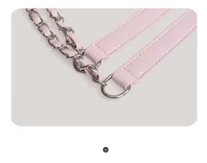 Detailed view of pink leather handbag strap combined with shiny silver metal chain hardware.