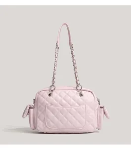 Pink quilted chain shoulder bag detail, featuring soft leather and metal hardware.