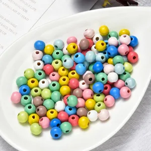 Close-up view of colorful wooden beads in macaron shades for DIY jewelry making and crafts.