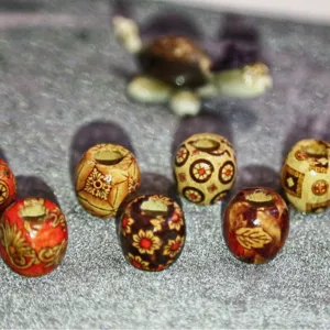 Close-up of vintage carved wooden beads featuring geometric and floral patterns for DIY craft.