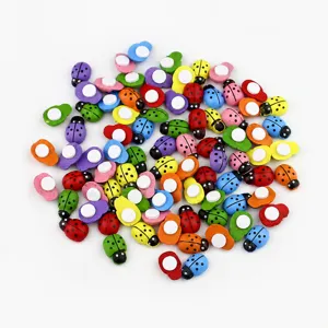 Wooden ladybug miniatures detail view, colorful cartoon insect figurines for micro landscape decor.