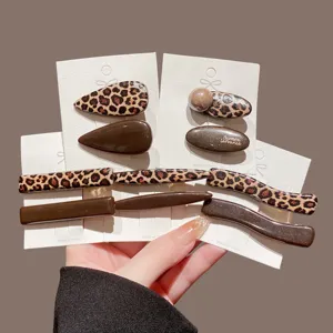 Leopard print and solid brown hair clip detail, showing stylish fashion accessory close-up.