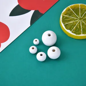 Detail shot of white wooden beads, various sizes craft round beads for DIY jewelry making accessories.