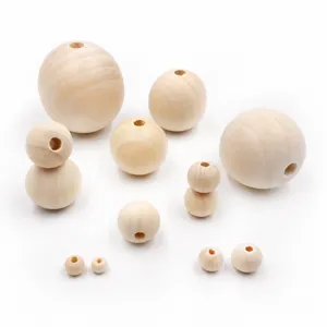 Gros plan de perles rondes en bois naturel, trous percés, accessoires de loisirs.