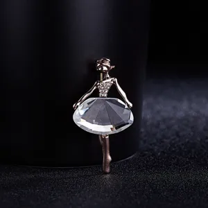 Detailed close-up view of elegant crystal ballerina brooch sparkling rhinestones accessory.