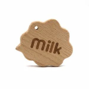 Beech wood baby teething toy detail, cloud shape with milk engraved pattern and hanging hole.