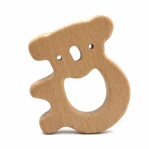 Close-up of cute wooden koala teether, smooth beech wood baby teething toy detail view.