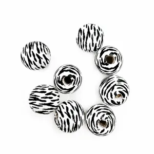 Close-up detail of black and white zebra print wooden beads for DIY jewelry craft making.