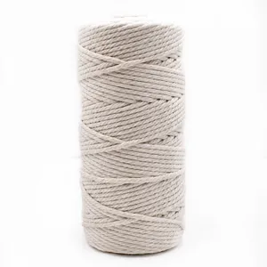 Close-up detail of beige 3mm macrame cotton cord roll for DIY handmade crafts and decor.