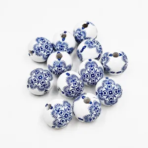 Close-up of 20mm blue and white porcelain style printed wooden round beads for DIY crafts.