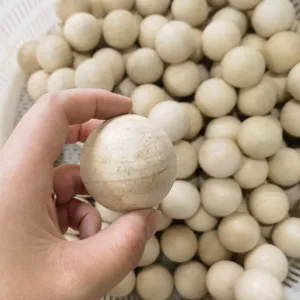 Natural wood beads detail shot, undrilled round Schima wood spheres 20-50mm for DIY crafts.