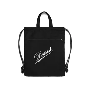 Detailed view of black nylon drawstring backpack with front zipper pocket and Dearest text.