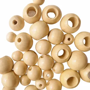 Close-up detail view of natural wood beads, assorted sizes large hole wooden loose craft beads.
