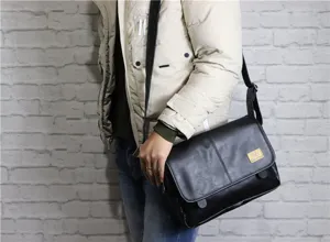 Detailed view of the black PU leather messenger bag with adjustable strap and vintage flap style.