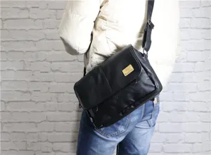 Black soft leather messenger bag for men, vintage casual shoulder bag with adjustable strap.