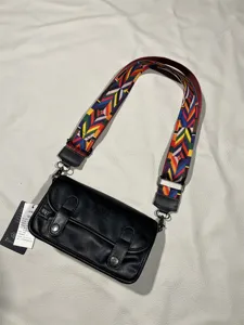 Three-box vintage black leather shoulder bag with colorful woven strap for daily street style.