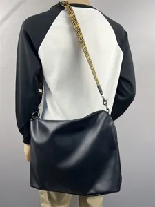 Men large capacity black leather shoulder bag with stylish yellow patterned strap detail.