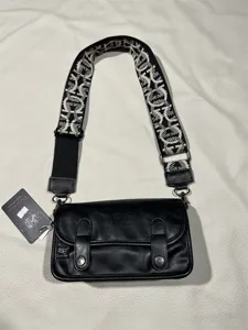 Black vintage crossbody bag for students, retro street style shoulder bag with wide strap.