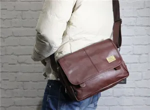 Detailed view of retro men brown leather messenger bag, vintage soft shoulder style.
