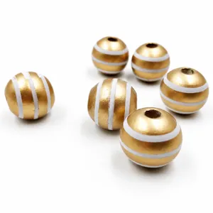 Detailed shot of 16mm painted wooden beads with golden and white striped design for DIY crafts.