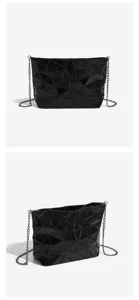 Detailed view of the black geometric lattice chain bag showcasing fine texture and links.