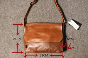 Close up detail view of brown leather messenger bag showing dimensions, retro cross body style.