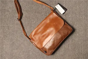 Brown leather messenger bag detail, vintage crossbody design with adjustable strap and flap.