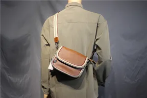 Casual crossbody shoulder bag detail, brown leather-look flap design with striped web strap.