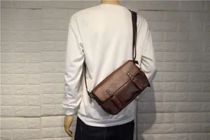 Detail view of the brown leather men's messenger bag, showing retro buckle and cross-body strap.