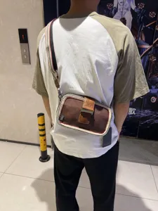 Vintage canvas crossbody bag for men and women, retro striped shoulder bag with metal buckle.