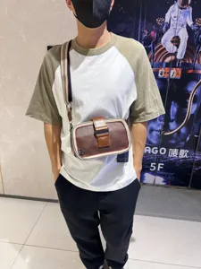 Detailed shot of retro striped canvas crossbody shoulder bag with buckle for men and women.