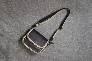 Stylish casual crossbody shoulder bag for men and women with striped strap design.