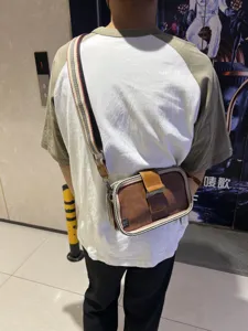 Retro striped men's crossbody bag with buckle, casual canvas shoulder bag for daily use.