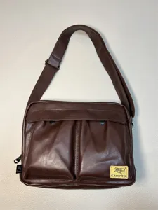 Brown PU leather messenger bag detail, casual vintage cross-body design with pockets.