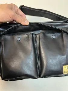 black faux leather crossbody messenger bag with double front pockets and adjustable strap