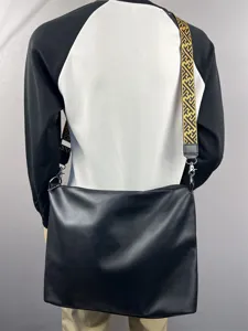 Men fashion black leather crossbody bag with geometric pattern wide strap detail view
