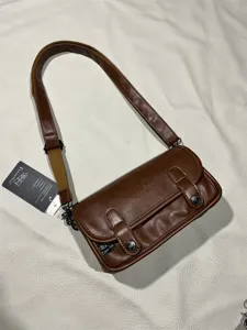 Retro brown PU leather crossbody bag for men and women, stylish street style shoulder bag.