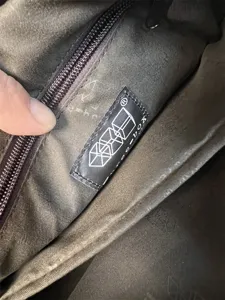 Interior detail showing fabric lining and brand label of the casual mens crossbody bag.
