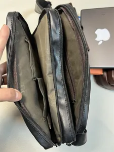 Black multi-compartment men shoulder bag interior detail view, casual messenger crossbody bag design.