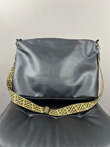 Men's black leather crossbody messenger bag with stylish woven strap for daily travel use.
