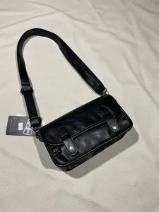 Black retro leather messenger bag for men and women, stylish streetwear shoulder bag.