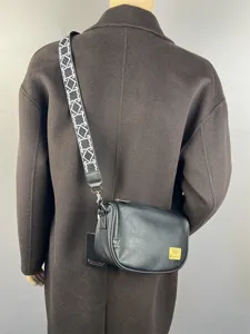 Black crescent cross body bag for men and women, casual Japanese style shoulder bag with strap.
